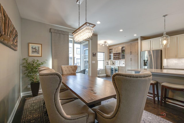 dining room with dark wood-style floors, recessed lighting, wine cooler, and baseboards