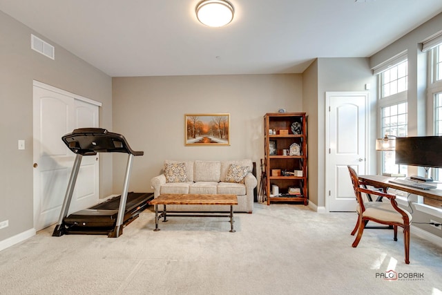 workout area featuring visible vents, baseboards, and carpet