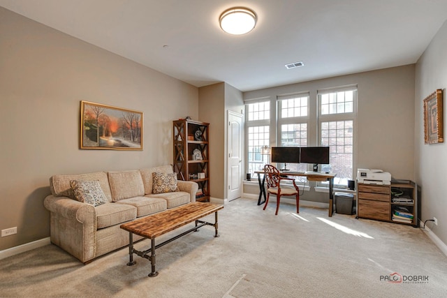 carpeted office space featuring baseboards and visible vents