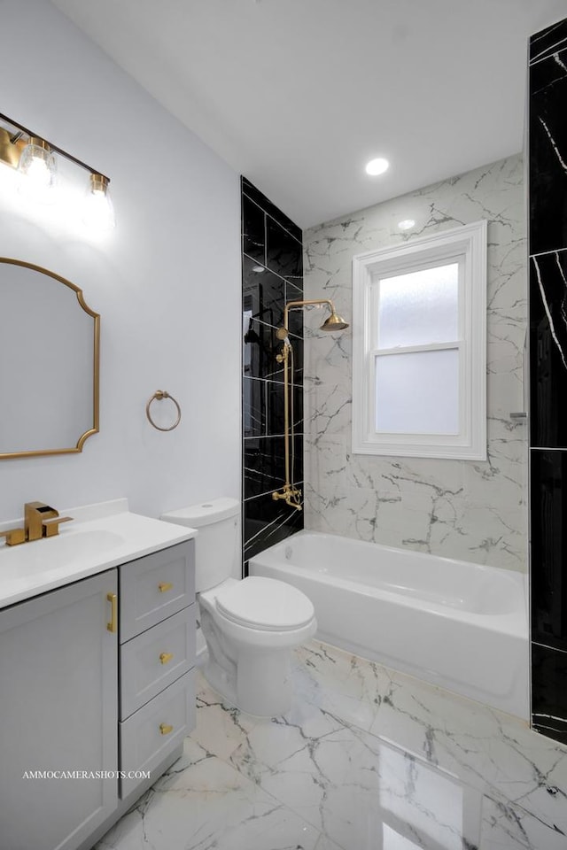 bathroom featuring marble finish floor, tub / shower combination, vanity, and toilet