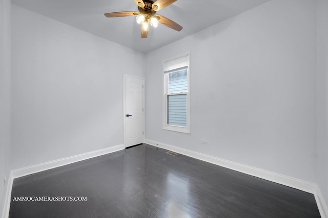 unfurnished room with a ceiling fan, dark wood-style flooring, and baseboards