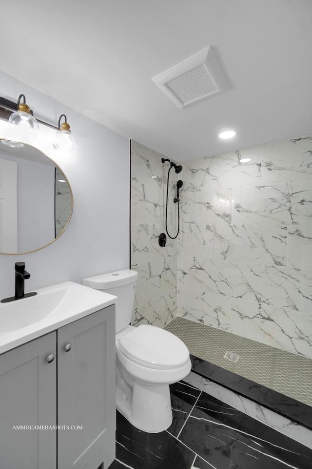 bathroom with marble finish floor, visible vents, toilet, vanity, and a walk in shower