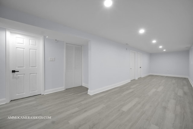 finished basement with light wood-style flooring, baseboards, and recessed lighting