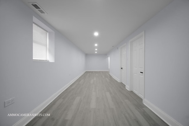 interior space featuring recessed lighting, wood finished floors, visible vents, and baseboards