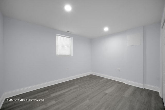 empty room featuring dark wood-type flooring, recessed lighting, and baseboards