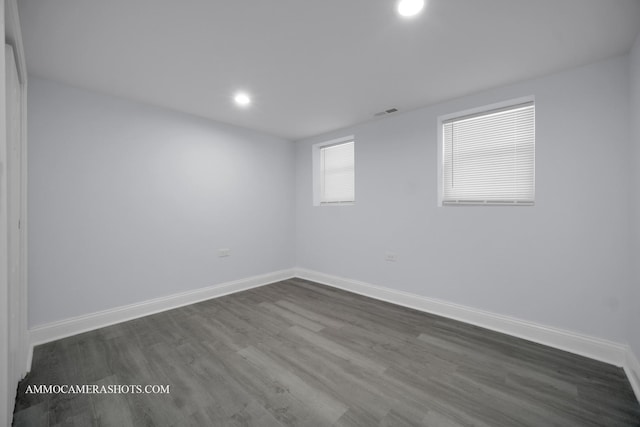 spare room with visible vents, baseboards, dark wood-style flooring, and recessed lighting