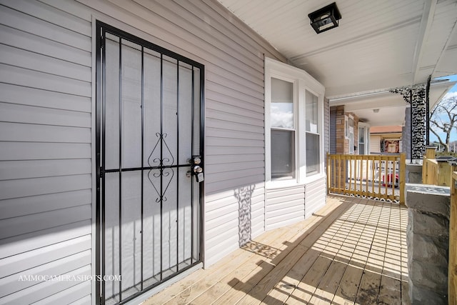 view of exterior entry featuring covered porch