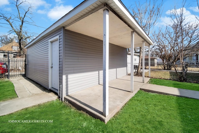 view of side of property with a lawn and fence