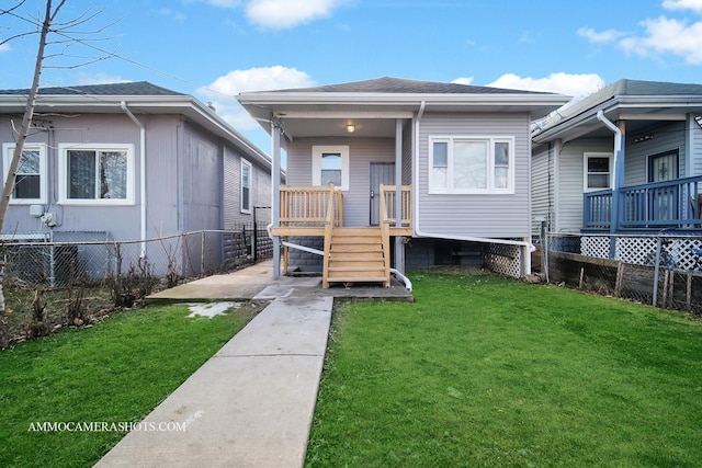 exterior space featuring roof with shingles, a yard, and fence