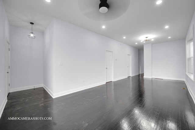 empty room featuring baseboards, ceiling fan, wood finished floors, and recessed lighting