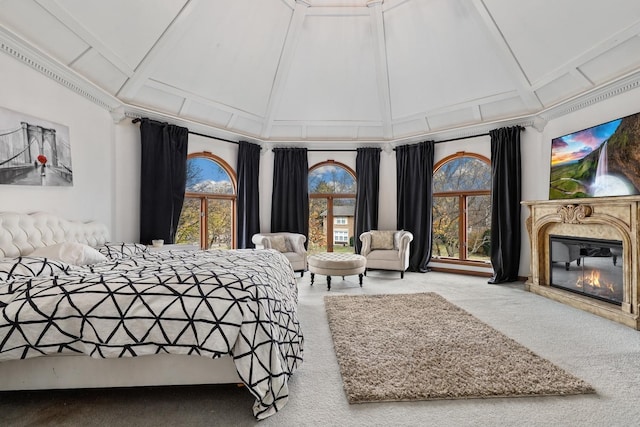 carpeted bedroom with high vaulted ceiling, beamed ceiling, and a premium fireplace