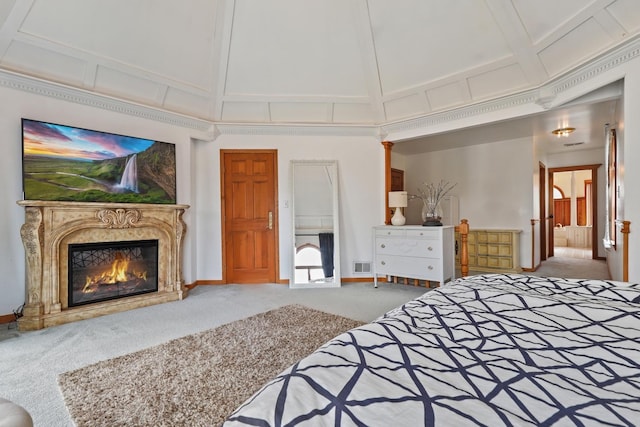 bedroom featuring carpet floors, baseboards, a premium fireplace, and visible vents