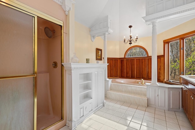 full bathroom with a garden tub, decorative columns, a notable chandelier, a shower with shower door, and tile patterned floors