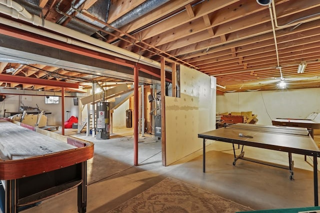 unfinished basement featuring stairway and gas water heater