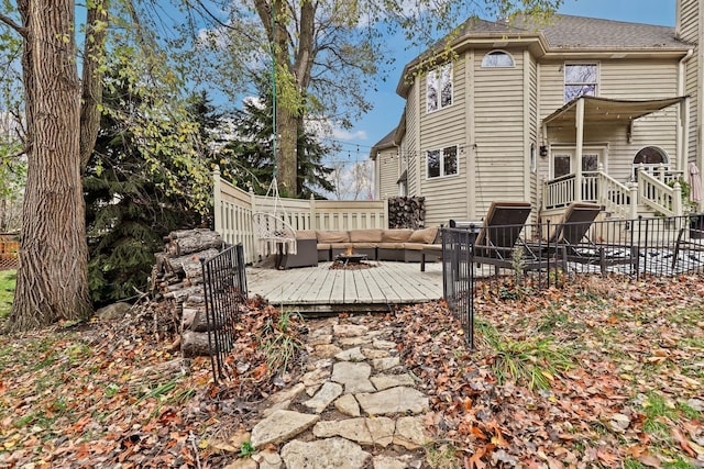 back of house with a deck, outdoor lounge area, and fence