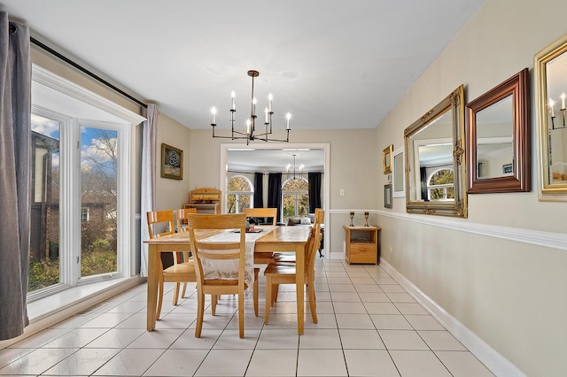 dining room with light tile patterned floors, baseboards, and a notable chandelier