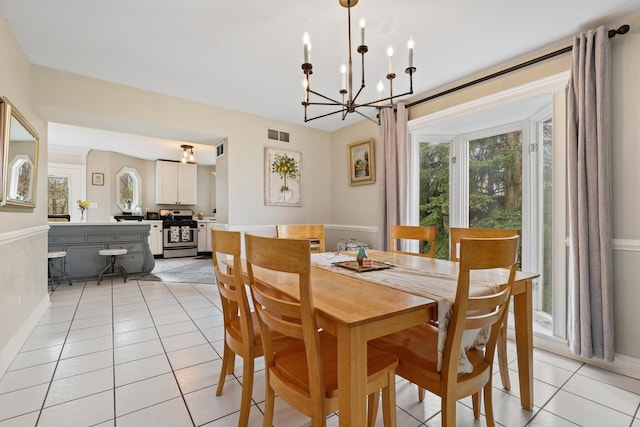 dining area featuring a notable chandelier, light tile patterned flooring, visible vents, and a healthy amount of sunlight