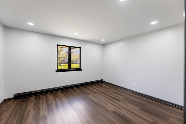 empty room featuring dark wood-style floors, a baseboard radiator, baseboards, and recessed lighting