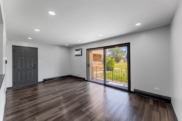 empty room with recessed lighting, baseboard heating, dark wood finished floors, and a wall mounted AC