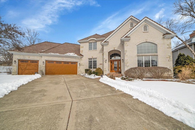 view of front of home with brick siding, driveway, and an attached garage