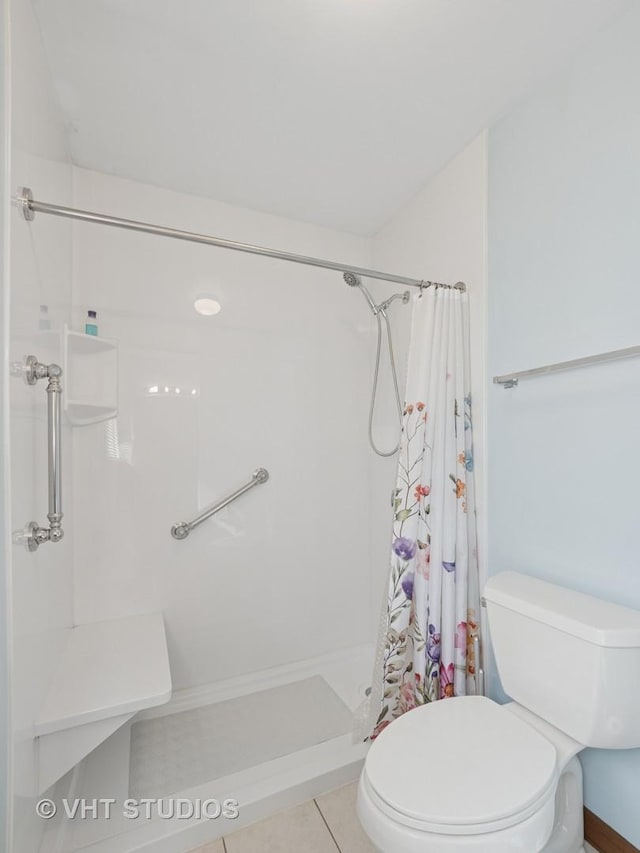 full bath with toilet, a shower stall, and tile patterned flooring