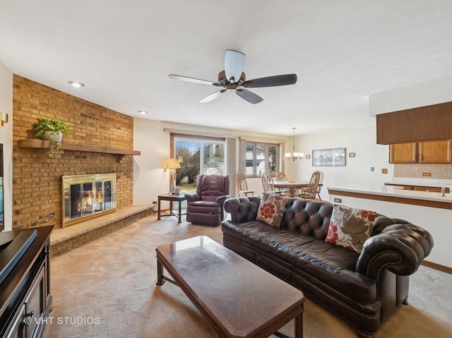 living area with a ceiling fan, light carpet, and a fireplace