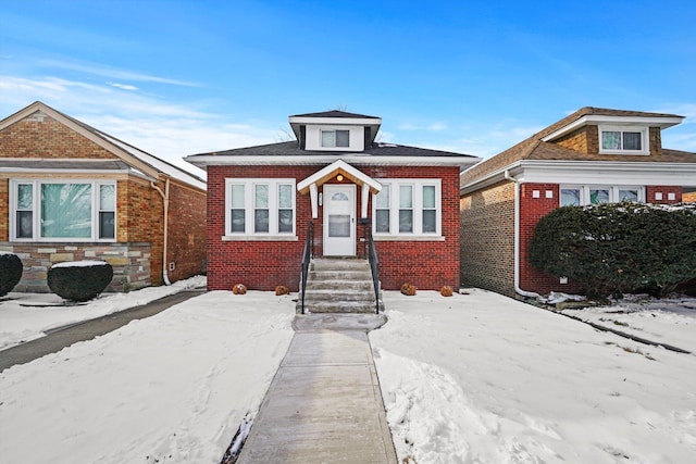 bungalow-style house featuring brick siding