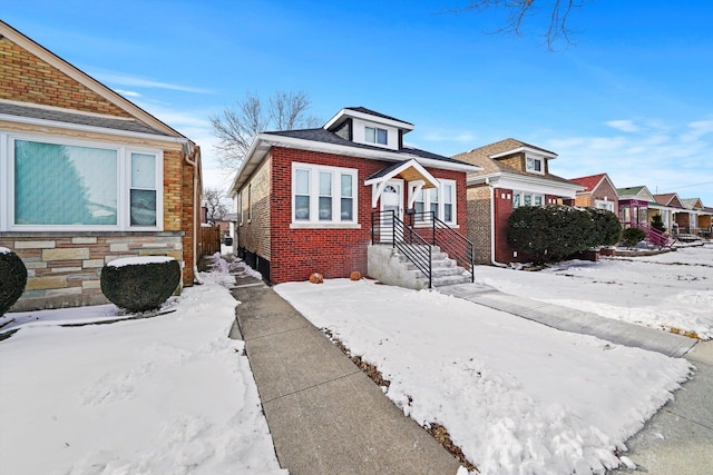 bungalow with a residential view and brick siding