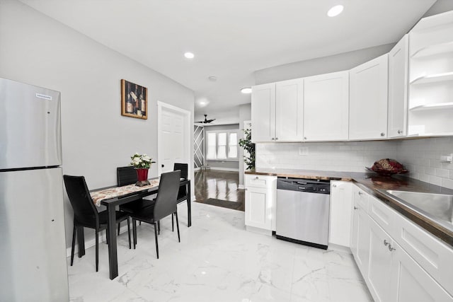 kitchen featuring decorative backsplash, marble finish floor, stainless steel appliances, white cabinetry, and open shelves