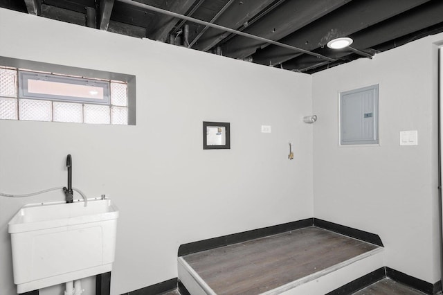 washroom featuring electric panel and baseboards