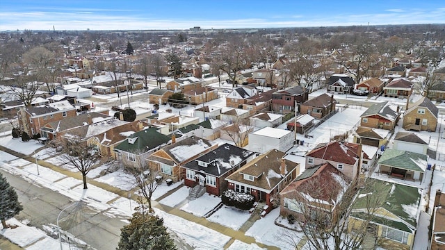 snowy aerial view featuring a residential view