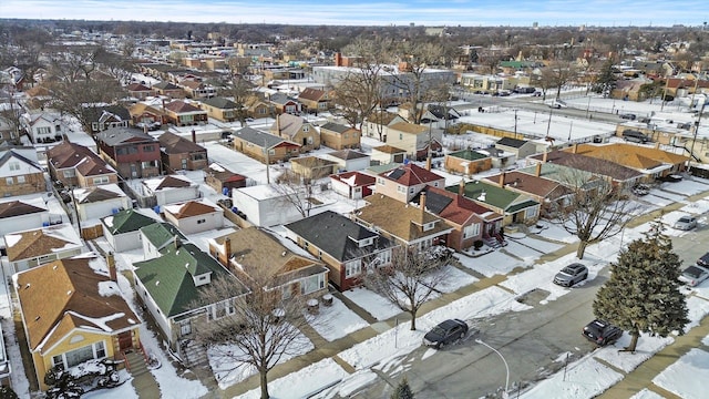 snowy aerial view with a residential view