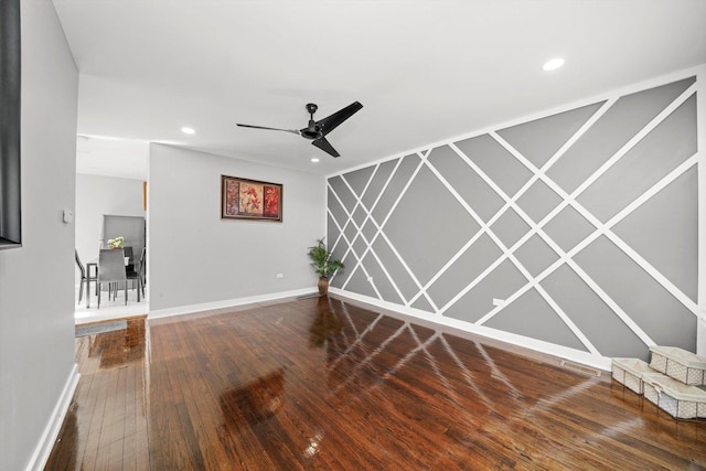 unfurnished room with ceiling fan, recessed lighting, wood finished floors, and baseboards