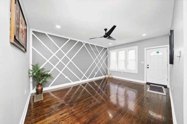 foyer with an accent wall, recessed lighting, baseboards, and wood finished floors