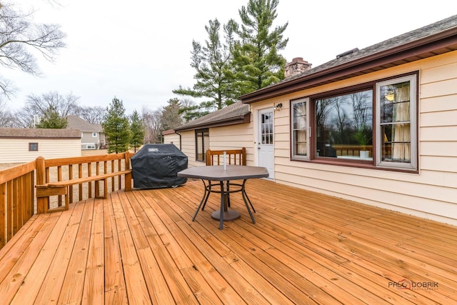 wooden terrace featuring area for grilling