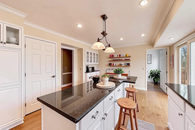 6 Robin Hood Ct, Lincolnshire, IL 60069 - kitchen with crown molding, light wood finished floors, a breakfast bar, and white cabinetry