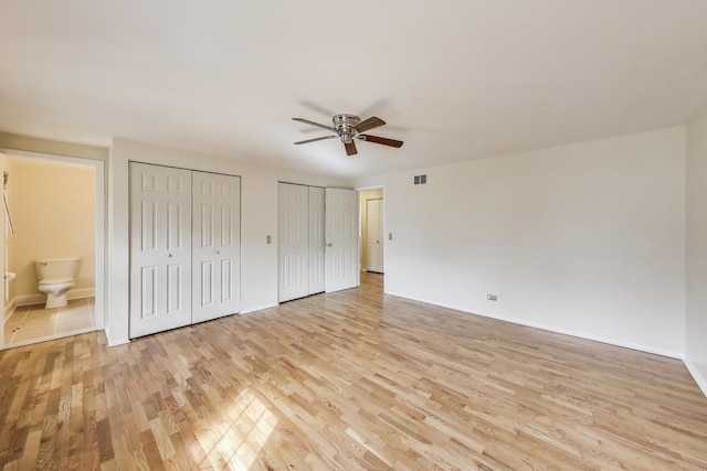 6 Robin Hood Ct, Lincolnshire, IL 60069 - unfurnished bedroom featuring light wood-type flooring, multiple closets, visible vents, connected bathroom, and baseboards