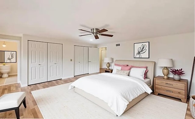 6 Robin Hood Ct, Lincolnshire, IL 60069 - bedroom featuring two closets, light wood-style flooring, a ceiling fan, connected bathroom, and baseboards
