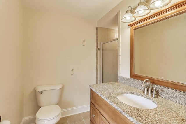 6 Robin Hood Ct, Lincolnshire, IL 60069 - bathroom featuring toilet, vanity, tile patterned floors, baseboards, and tiled shower