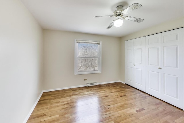 6 Robin Hood Ct, Lincolnshire, IL 60069 - unfurnished bedroom featuring a closet, visible vents, baseboards, ceiling fan, and light wood-style floors