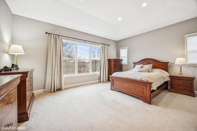 bedroom featuring baseboards, light carpet, a raised ceiling, and recessed lighting