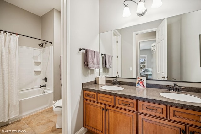 full bath with double vanity, shower / tub combo, toilet, and a sink