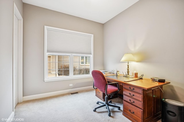 office area with light colored carpet, visible vents, and baseboards