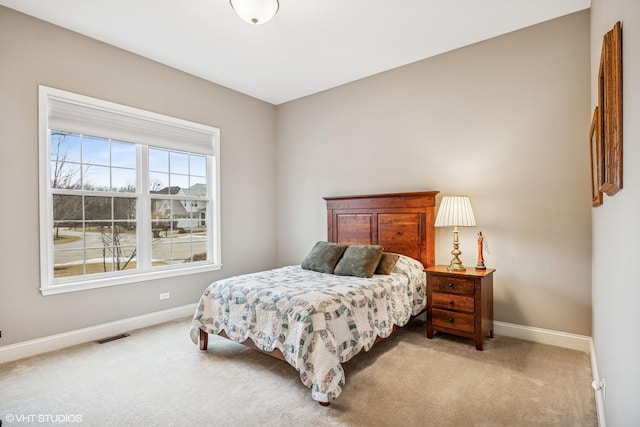 bedroom featuring light carpet, visible vents, and baseboards