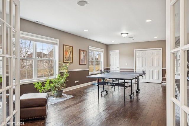 playroom with recessed lighting, dark wood finished floors, a wealth of natural light, and french doors