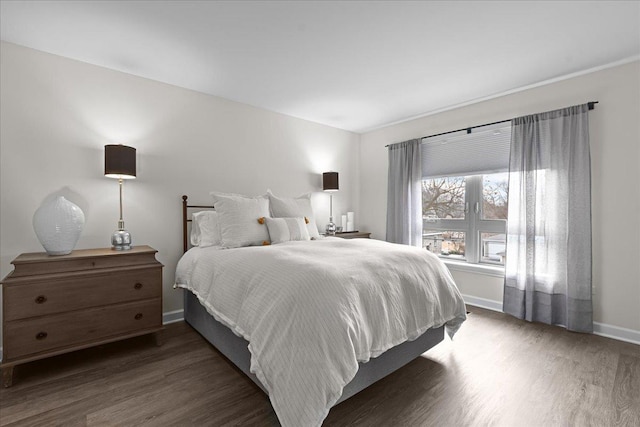 bedroom featuring dark wood-style floors and baseboards