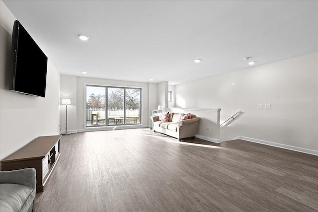 unfurnished living room featuring recessed lighting, baseboards, and wood finished floors