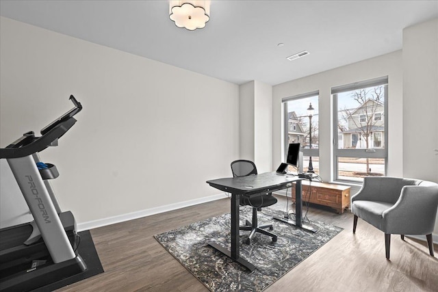 office space featuring dark wood-style floors, visible vents, and baseboards