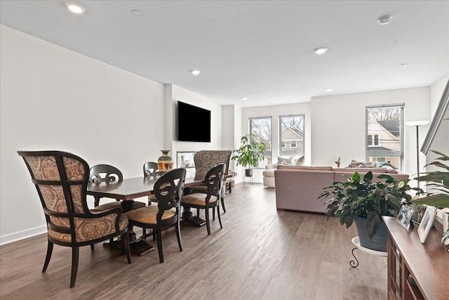 dining area featuring recessed lighting, wood finished floors, and baseboards