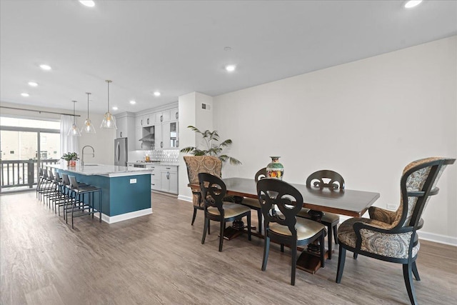 dining area featuring visible vents, baseboards, wood finished floors, and recessed lighting